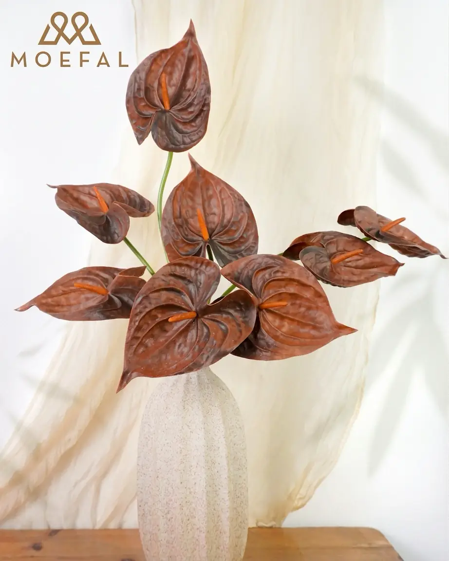 Coffee brown real-touch artificial anthurium stems in a speckled off-white vase