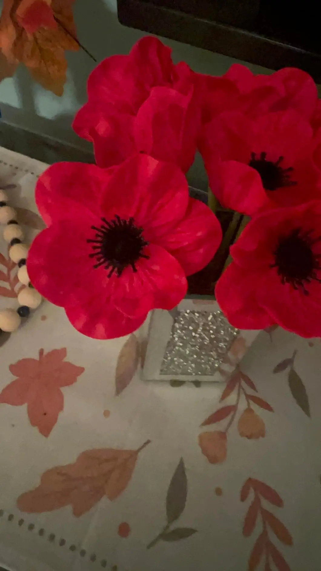 Close-up of red anemone poppies in a glitter vase