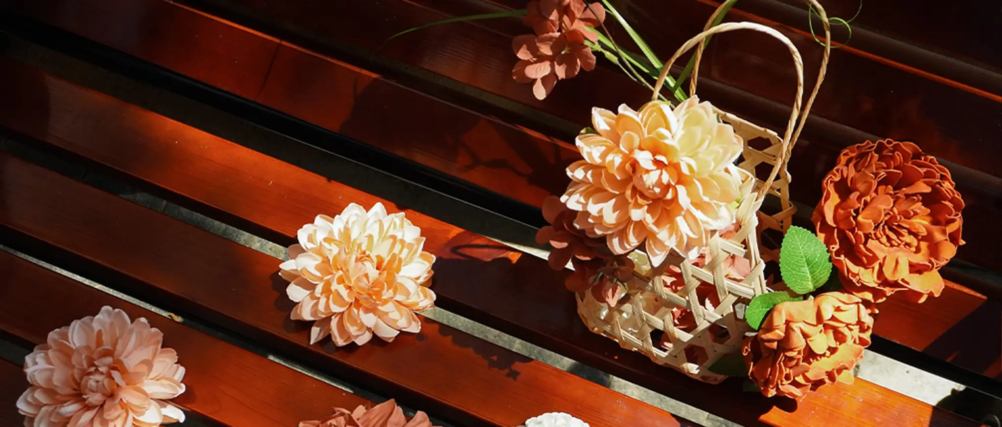 MOEFAL autumn new arrivals: terracotta and peach artificial dahlias and peonies with a woven basket on a sunlit wooden bench