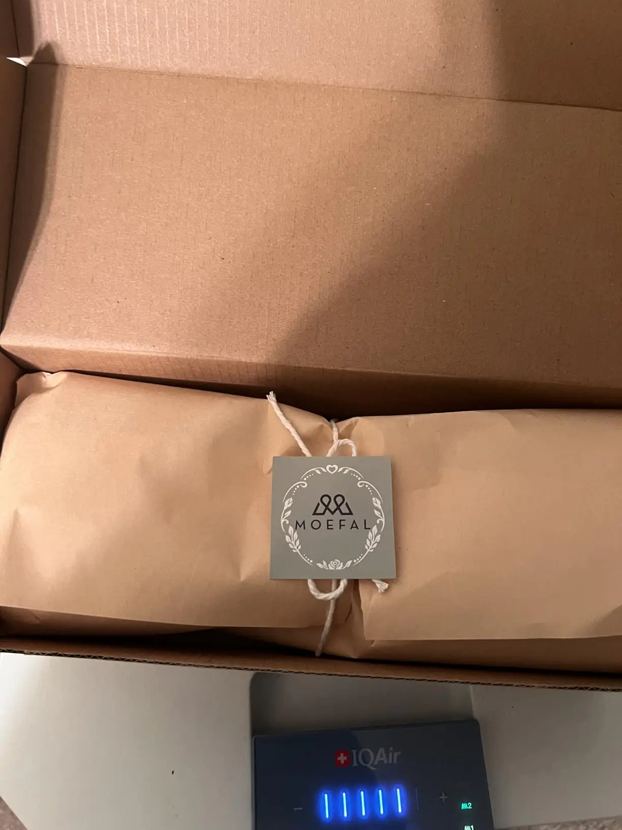 MOEFAL kraft wrap with branded tag inside the shipping box