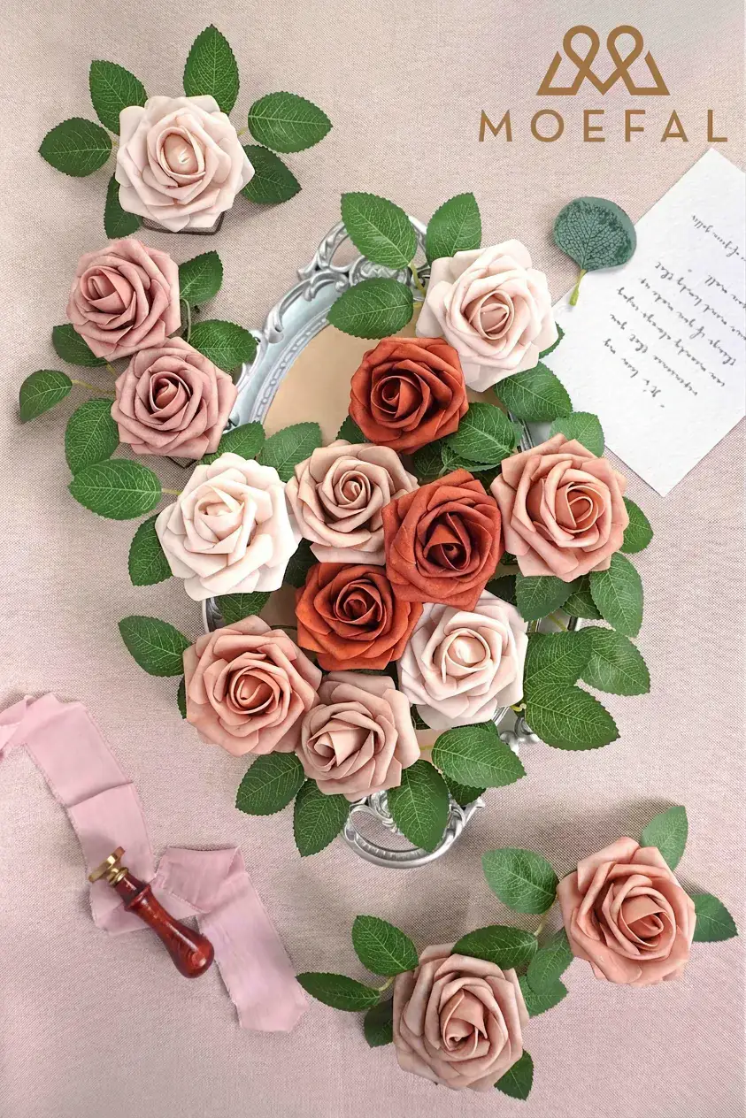 Blush, dusty rose and terracotta foam roses arranged on a vintage tray