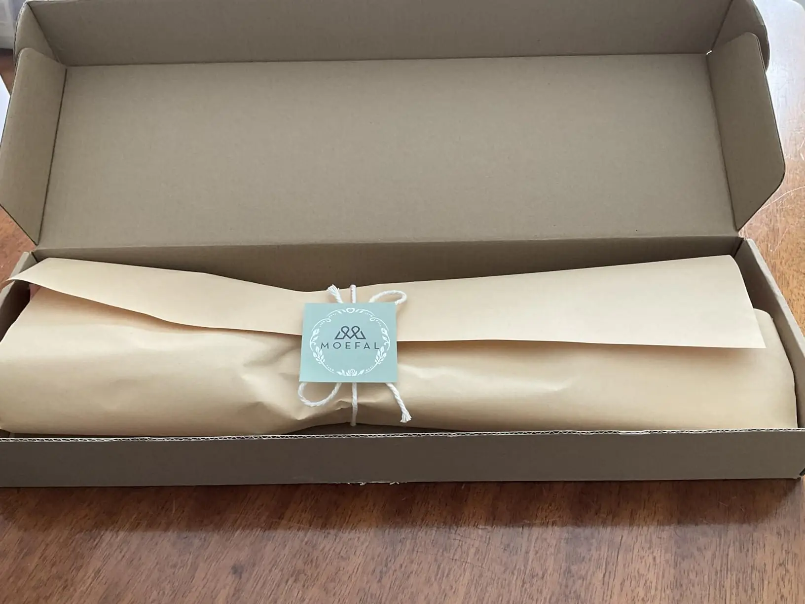 MOEFAL branded kraft wrap and tag inside the shipping box