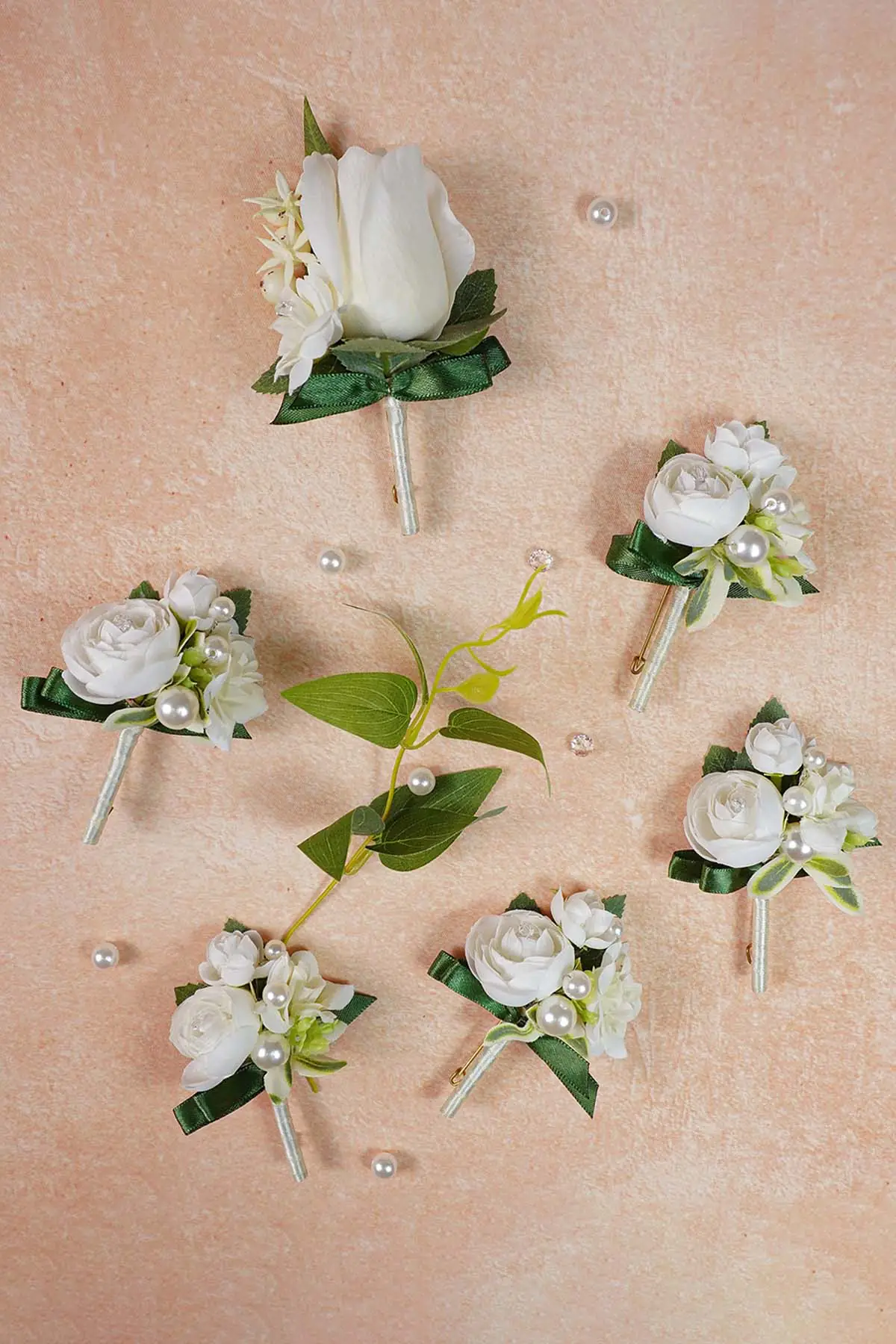 White rose boutonniere set for groom and groomsmen wedding attire