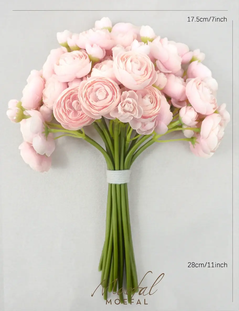 The full blush pink ranunculus bouquet is laid flat showing its height and width.