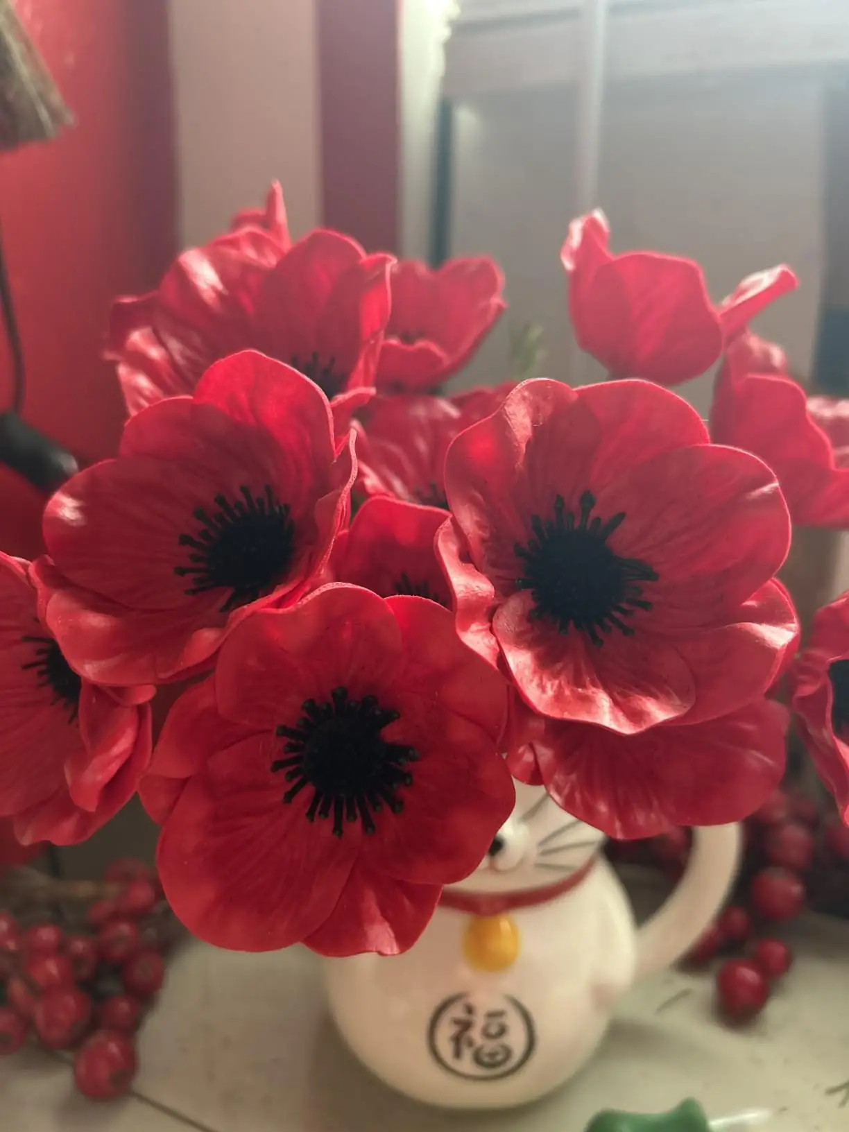 Red anemone poppies in a white ceramic pot