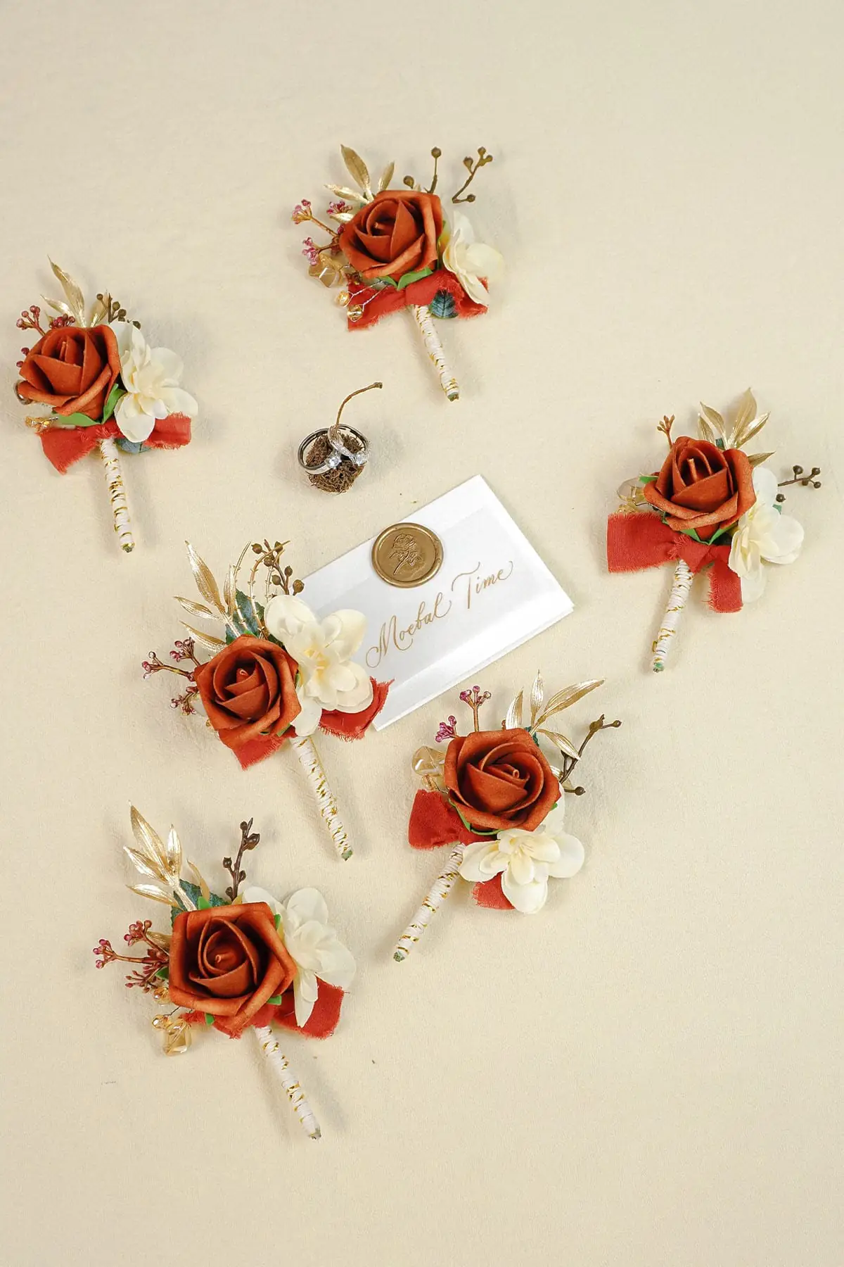 Terracotta rose boutonniere set for groom and groomsmen wedding attire
