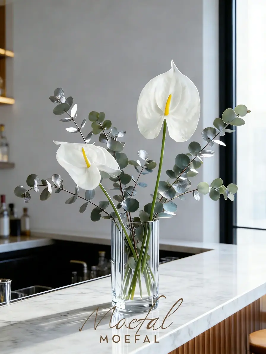 White faux anthuriums in a vase bringing the biophilic design trend indoors.