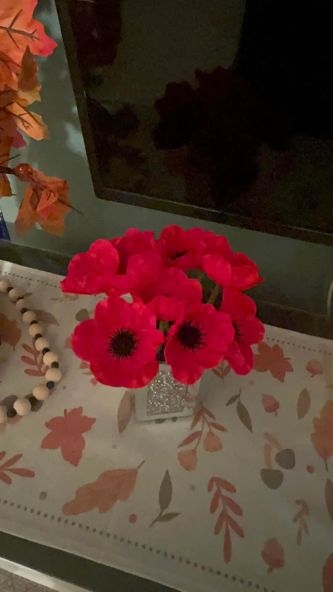 Red anemone poppy arrangement on a console table
