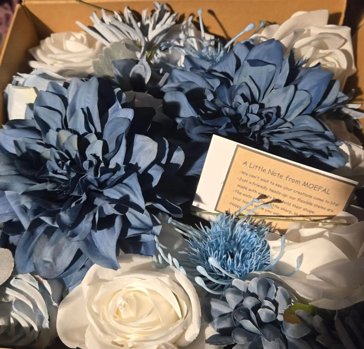 Dusty blue and navy silk dahlias with white roses and a MOEFAL note card inside the shipping box