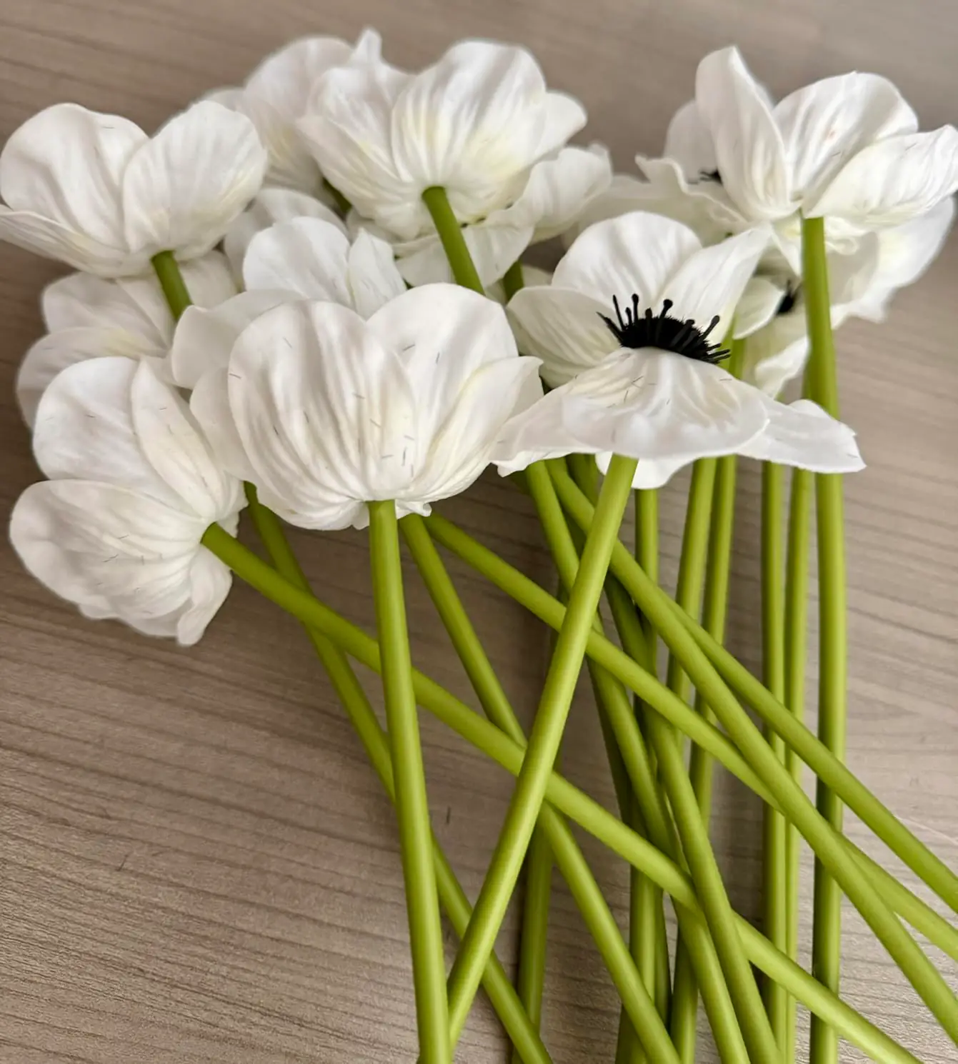 White anemone poppies wrapped in brown kraft paper