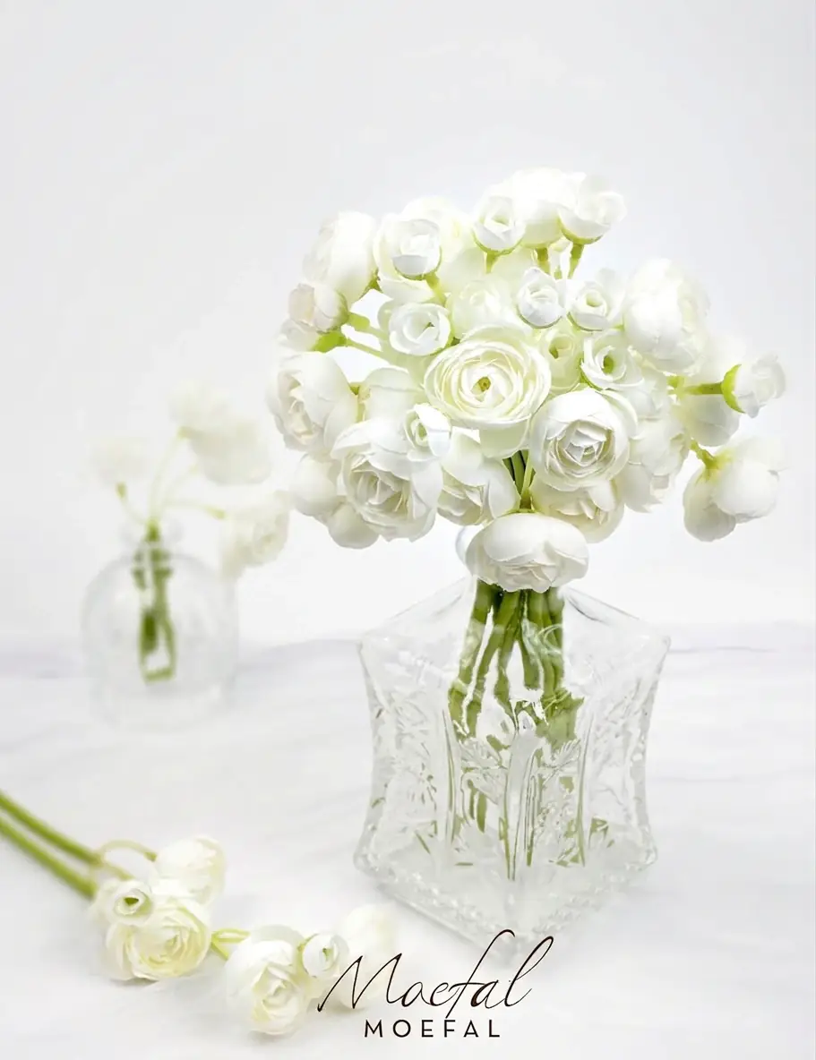 Ivory white mini ranunculus in a vintage clear glass vase